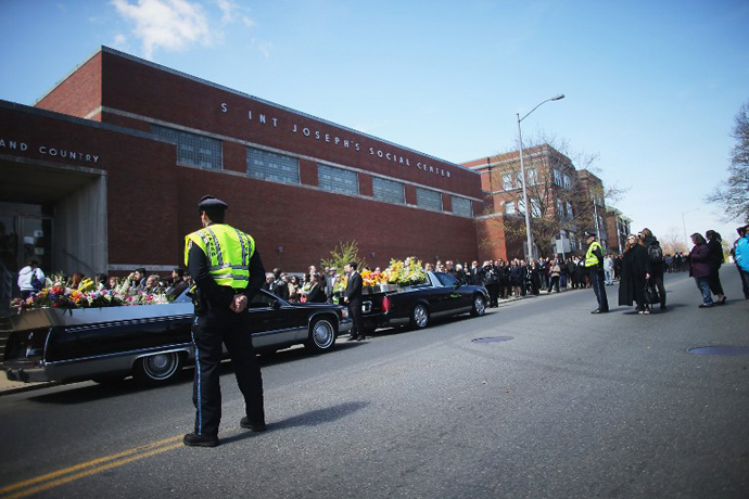 People wait on line to attend the funeral for 29-year-old Krystle Campbell who was one of three people killed in the Boston Marathon bombings on April 22, 2013 in Medford, Massachusetts. (AFP Photo / Mario Tama)