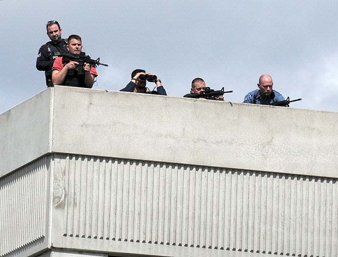 Snipers take positions on a rooftop during the manhunt in Watertown, Massachusetts, for the second suspect in the Boston Marathon bombing who is still at large on April 19, 2013. (AFP Photo/John Mottern)