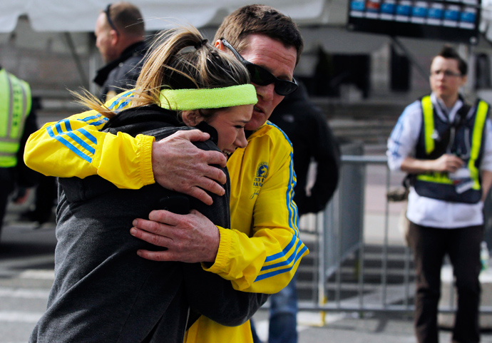 A woman is comforted by a man near a triage tent set up for the Boston Marathon after explosions went off at the 117th Boston Marathon in Boston, Massachusetts April 15, 2013 (Reuters / Jessica Rinaldi)