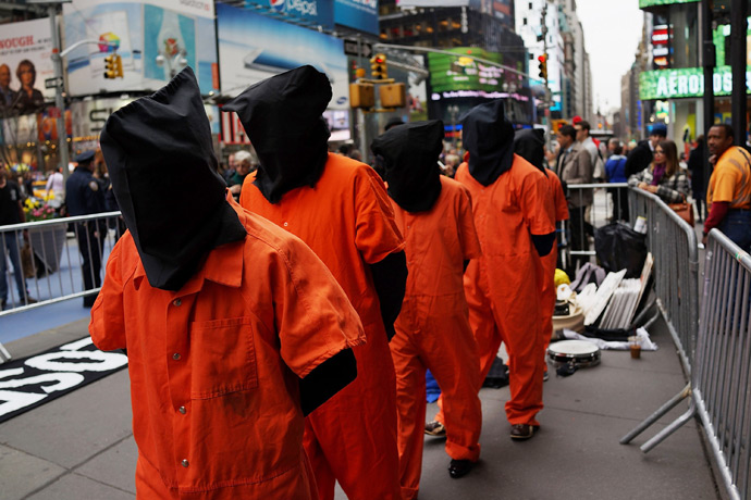 Activists in Times Square, dressed in orange prison jumpsuits, participate in a nationwide "Day of Action to Close Guantanamo & End Indefinite Detention" on April 11, 2013 in New York City (AFP Photo / Spencer Platt)