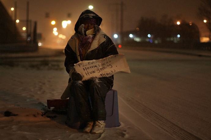 A homeless woman begs for money at an intersection in Detroit, Michigan. (Spencer Platt/Getty Images/AFP)