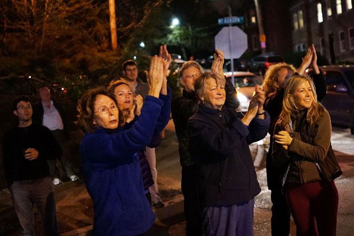 Women cheer police as they exit Franklin Street after 19-year-old bombing suspect Dzhokhar A. Tsarnaev was apprehended on April 19, 2013 in Watertown, Massachusetts. (Spencer Platt/Getty Images/AFP)