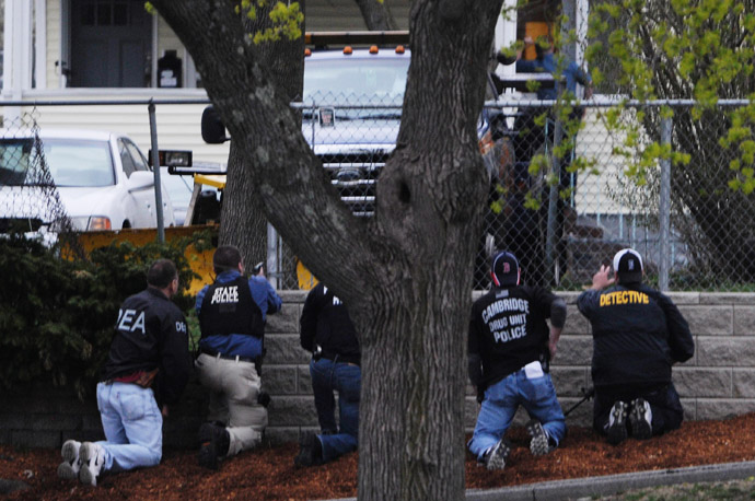 Law enforcement approach an area reportedly where a suspect is hiding on Franklin St., on April 19, 2013 in Watertown, Massachusetts. (Darren McCollester/Getty Images/AFP)