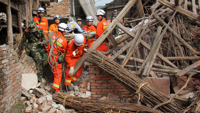 Rescuers carry a paralysed elderly man from his damaged house in Qingren township in seriously damaged Lushan county after a shallow earthquake at magnitude 7.0 hit the city of Ya'an, in southwest China's Sichuan province on April 20, 2013.(AFP Photo / China OUT)