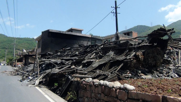 Collapsed houses are seen after an earthquake of 6.6 magnitude, on the side of a road leading from Ya'an city to Luzhou county, in Ya'an, Sichuan province April 20, 2013.(Reuters / Stringer)