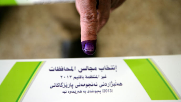 An internally displaced Iraqi shows his ink-stained finger indicating he cast a ballot at a polling station in the northern Iraqi Kurdish city of Arbil, on April 20, 2013.(AFP Photo / Ahmad Al-Rubaye)