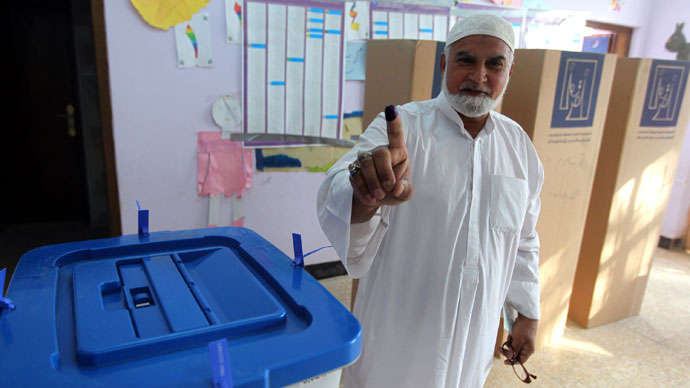 An Iraqi man shows his ink-stained finger indicating he cast a ballot at a polling station during provincial elections on April 20, 2013 in Baghdad.(AFP Photo / Ahmad Al-Rubaye)