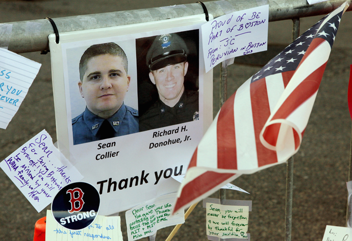A tribute to MIT police officer Sean Collier (L), killed by the Boston marathon bombing suspects and MBTA police officer Richard Donahue, Jr. (R), shot and injured in a shoot out with the suspects, is seen at a memorial to the victims of the Boston Marathon bombings near the scene of the blasts on Boylston Street in Boston, Massachusetts, April 21, 2013. ( Reuters / Jim Bourg)