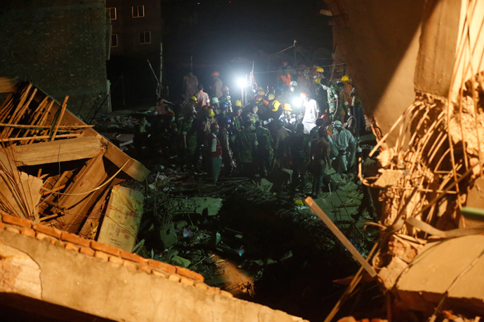 Rescue workers attempt to rescue garment workers from the rubble of the collapsed Rana Plaza building, in Savar, 30 km (19 miles) outside Dhaka April 28, 2013 (Reuters / Andrew Biraj)
