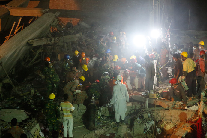 Rescue workers attempt to rescue their colleagues after a fire inside the rubble of the collapsed Rana Plaza building, in Savar, 30 km (19 miles) outside Dhaka April 28, 2013 (Reuters / Andrew Biraj)