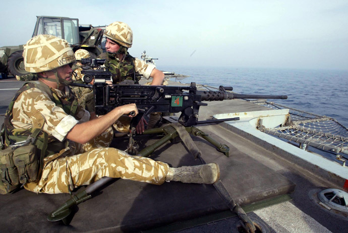 Royal Marines practice their drill using a Browning heavy machine gun on the deck of HMS Ocean as it travels through the Persian Gulf. (AFP Photo)