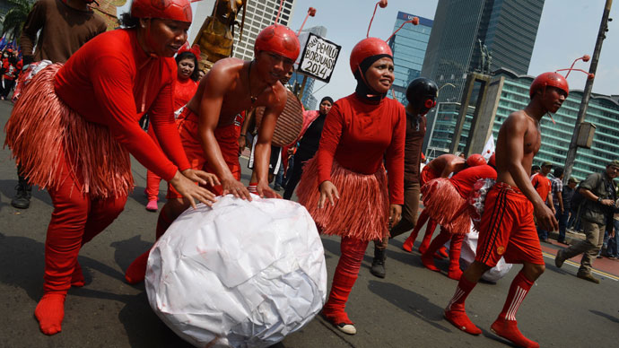 Indonesian workers wearing costumes symbolizing ants to depict wokers exploitation join a march by thousands to the presidential palace in Jakarta on May 1, 2013.(AFP Photo / Romeo Gacad)