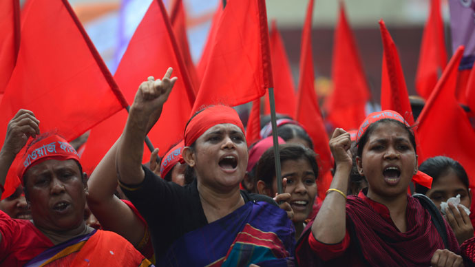 Bangladeshi activists shout slogans and wave flags during a procession to mark May Day or International Workers Day in Dhaka on May 1, 2013.(AFP Photo / Munir uz Zaman)