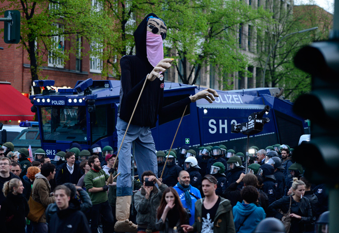 Protesters operate a giant puppet dressed a a demonstrant as they take part in the 'Revolutionary' May Day demonstration on May 1, 2013 in Berlin (AFP Photo / John Macdougall) 