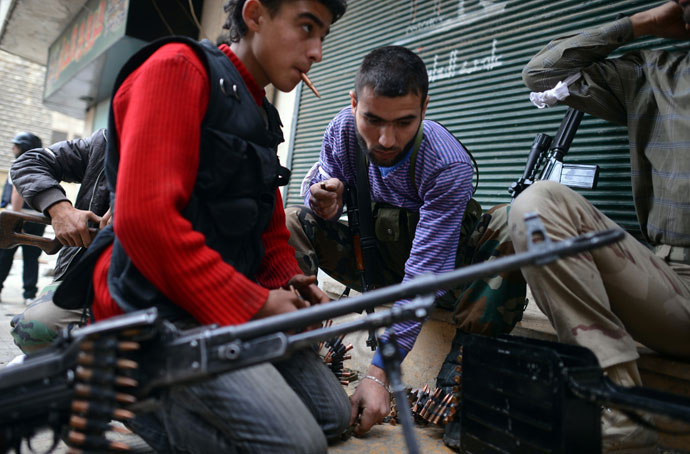 Rebel fighters load their weapons in the majority-Kurdish Sheikh Maqsud district of the northern Syrian city of Aleppo on April 4, 2013.(AFP Photo / Dimitar Dilkoff)