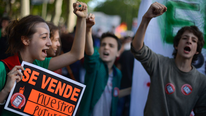 A student holds a placard reading "For sale: our future" as she takes part with thousands of people in a protest against the government's cuts to education spending in Madrid, on May 9, 2013.(AFP Photo / Pedro Armetre)