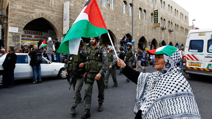 A Palestinian protestor holds a Palestinian flag during a demonstration for Nakba (Catastrophe) day, near Damascus Gate at Jerusalem's old city May 15, 2013.(Reuters / Ammar Awad)