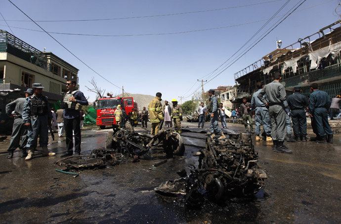 Afghan policemen stand guard at the site of a suicide attack in Kabul May 16, 2013. (Reuters)