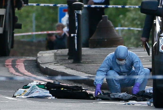 A police forensics officer investigates a crime scene where one man was killed in Woolwich, southeast London May 22, 2013 (Reuters / Stefan Wermuth)