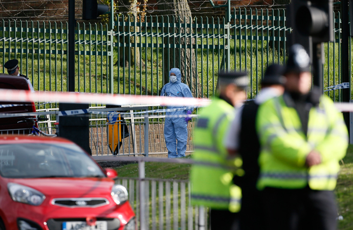 A police forensics investigator (C) approaches a crime scene where one man was killed in Woolwich, southeast London May 22, 2013 (Reuters / Stefan Wermuth)