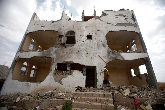 A tribesman walks near a building damaged last year by a U.S. drone air strike targeting suspected al Qaeda militants in Azan of the southeastern Yemeni province of Shabwa (Reuters / Khaled Abdullah)