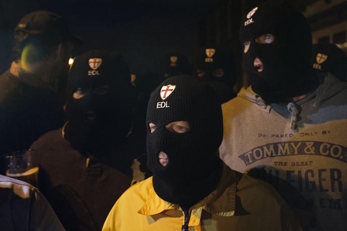 Members of the English Defence League (EDL) wear balaclavas as they gather outside a pub in Woolwich in London on May 22, 2013 after a man believed to be a serving British soldier was brutally murdered nearby in what Prime Minister David Cameron said appeared to be a terrorist attack (AFP Photo / Justin Tallis)