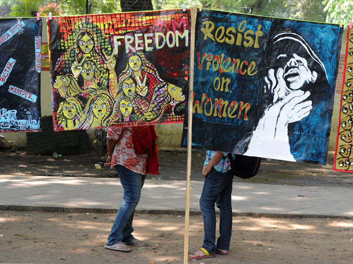 Demonstrators stand behind posters during a protest rally in New Delhi on February 21, 2013. Demonstrators called for changes in a proposed law against sexual crimes, saying it needed to be stronger and more defined. (AFP Photo / Sajjad Hussain)