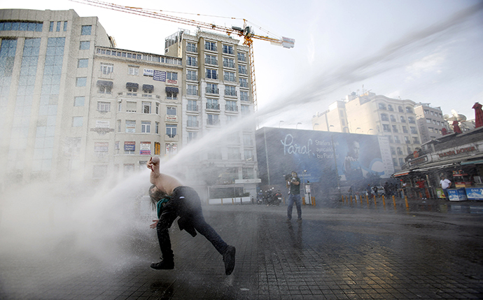 Turkish riot police use water cannon to disperse demonstrators during a protest against the destruction of trees in a park brought about by a pedestrian project, in Taksim Square in central Istanbul May 31, 2013. (Reuters / Murad Sezer)