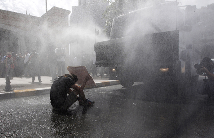 Turkish riot police use water cannon to disperse demonstrators during a protest against the destruction of trees in a park brought about by a pedestrian project, in Taksim Square in central Istanbul May 31, 2013. (Reuters / Osman Orsal)
