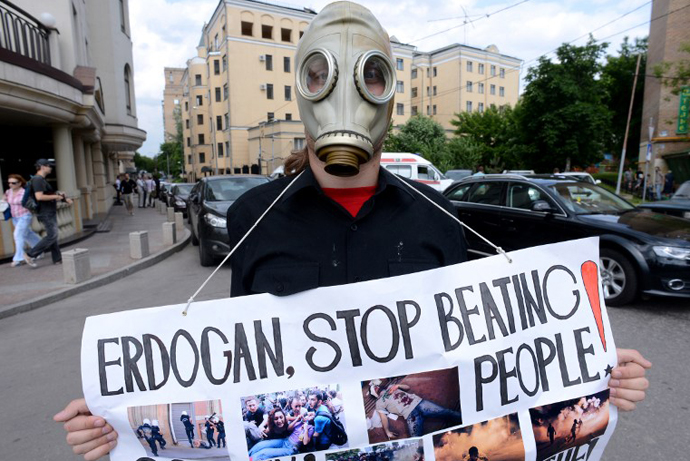 A Russian anarchist activist holds a cardboard during a protest against Turkey's Prime Minister Recep Tayyip Erdogan held near the Turkish embassy in Moscow on June 10, 2013. (AFP Photo / Kirill Kudryavtsev)