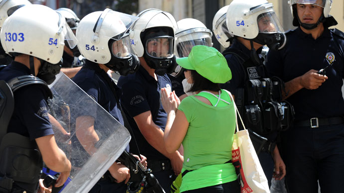 A women asks police to stop as Turkish protestors and riot policemen clash in Taksim Square in Istanbul on June 1, 2013. (AFP Photo / Bulent Kilic)