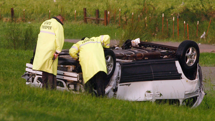 Oklahoma Highway Patrol Troopers look at a flipped SUV, which was blown off of Interstate-40 eastbound by a tornado, just east of El Reno, Oklahoma May 31, 2013.(Reuters / Bill Waugh)