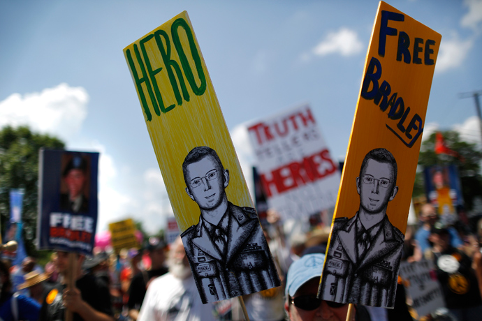 A protester carries a sign reading 'Hero' with a picture of jailed U.S. Army Private Bradley Manning, a central figure in the Wikileaks case, as marchers rally to call for his release, outside the gates at Fort Meade, Maryland, June 1, 2013 (Reuters / Jonathan Ernst)