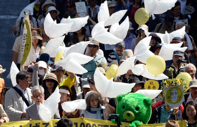 Japanese authors, Kenzaburo Oe (front row L) and Keiko Ochiai (front row C) lead a march holding dove-shape balloons to protest against nuclear power plants, following the March 2011 Fukushima meltdown-disasters, in Tokyo on June 2, 2013. (AFP Photo / Toshifumi Kitamura)
