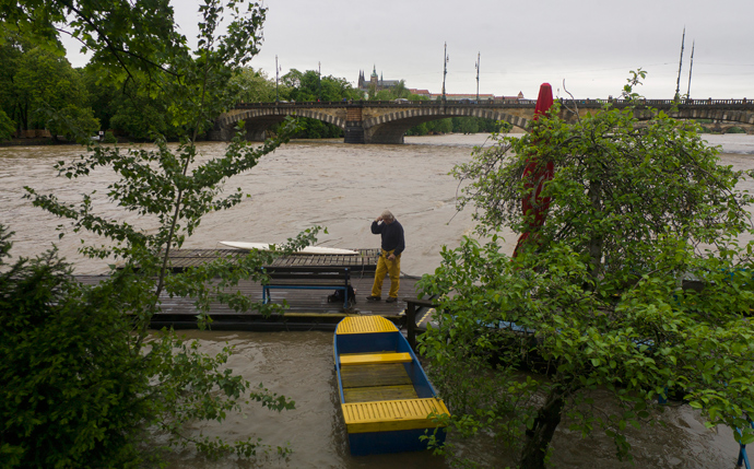 A man stands on a footbridge in the flooded Vltava river on June 2, 2013 in Prague (AFP Photo / Michael Cizek)