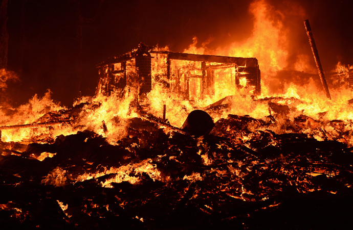 Fire engulfs a house as firefighters battle the Powerhouse wildfire at the Angeles National Forest, with the fire now having destroyed several homes near the Lake Hughes area in California June 1, 2013 (Reuters / Gene Blevins)