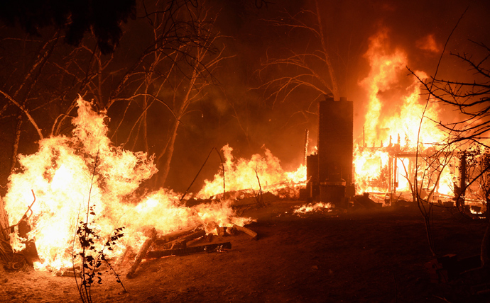 Fire engulfs a house as firefighters battle the Powerhouse wildfire at the Angeles National Forest, with the fire now having destroyed several homes near the Lake Hughes area in California June 1, 2013