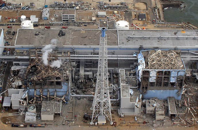 The stricken Tokyo Electric Power Company (TEPCO) Fukushima daiichi No.1 nuclear power plant reactor number three and four, with smoke rising from number three at Okuma town in Fukushima prefecture. (AFP Photo / Air Photo Service)