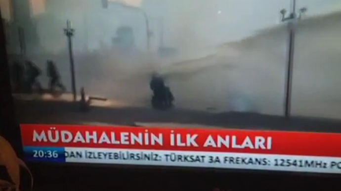 Riot police fire water cannon at protester in wheelchair at Taksim