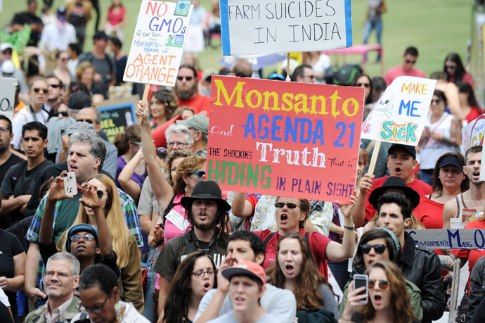 People carry signs during a protest against agribusiness giant Monsanto in Los Angeles on May 25, 2013. (AFP Photo)