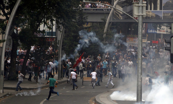 People run to avoid tear gas during protests at Kizilay square in central Ankara, June 16, 2013. (Reuters)