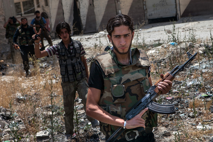 Syrian rebel fighters belonging to the "Martyrs of Maaret al-Numan" battalion leave their position after a range of shootings in the northwestern town of Maaret al-Numan in front of the army base of Wadi Deif, down in the valley (AFP Photo / Daniel Leal-Olivas)