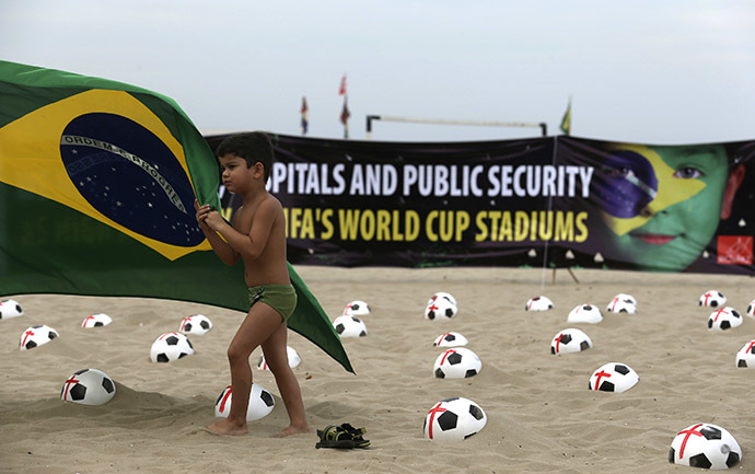 Soccer balls marked with red crosses planted by members of NGO Rio de Paz (Rio Peace) as a protest in Copacabana beach in Rio de Janeiro June 22, 2013. (Reuters / Pilar Olivares)
