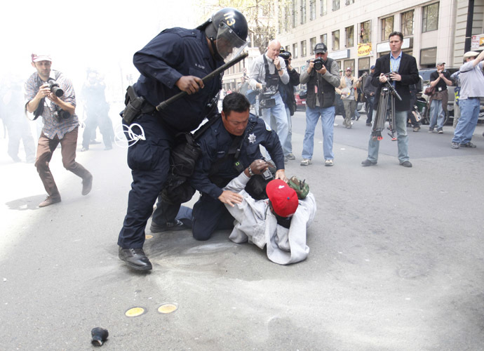 Oakland police officers try to detain an Occupy Oakland protester near City Hall in downtown Oakland, California, during the May Day protest on May 1, 2012. (AFP Photo/Kimihiro Hoshino)