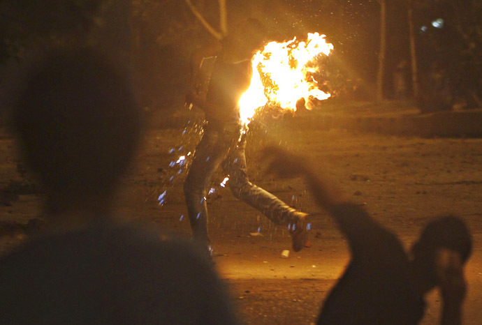 A protester who opposes Egyptian President Mohamed Morsi runs after a Molotov cocktail burns him during the attack of national headquarters of the Muslim Brotherhood in Cairo's Moqattam district June 30, 2013. (Reuters)