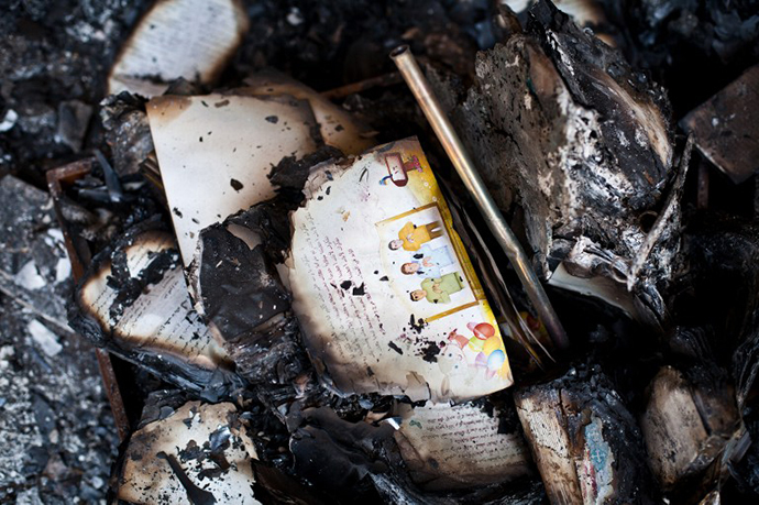 A picture taken on August 18, 2013 shows burnt books in the Amir Tadros coptic Church in Minya, some 250 kms south of Cairo, which was set ablaze on August 14, 2013. (AFP Photo / Virginie Nguyen Hoang)