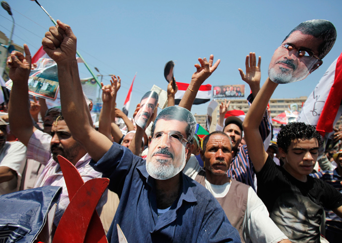 Members of the Muslim Brotherhood and supporters of ousted Egyptian President Mohamed Mursi shout slogans during a rally around Rabaa Adawiya square where they are camping, in Cairo July 26, 2013 (Reuters / Amr Abdallah Dalsh)