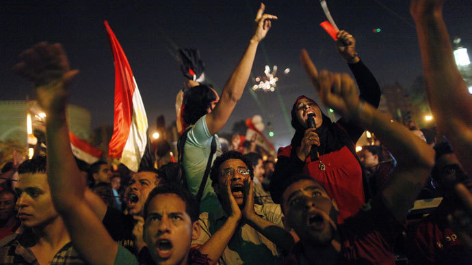 Egyptian protesters calling for the ouster of President Mohamed Morsi react as they watch his speech on a screen in a street leading to presidential palace early in Cairo on July 3, 2013.(AFP Photo / Mahmud Khaled)