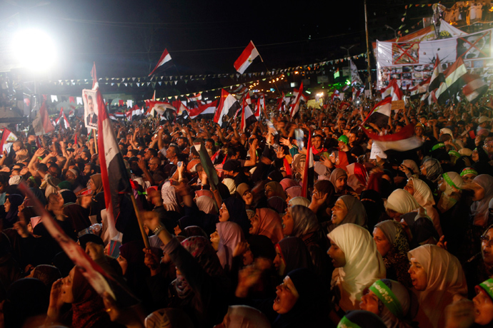 Supporters of Egypt's deposed President Mohamed Mursi shout slogans as they continue their sit-in outside the Rabaa Adawiya mosque, east of Cairo July 11, 2013 (Reuters / Asmaa Waguih) 