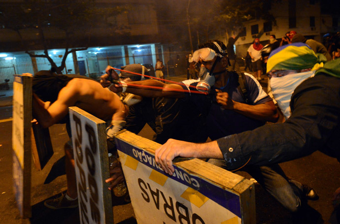 Violent demonstrators attack the police during a protest in a street near the Maracana stadium of Rio de Janeiro on June 30, 2013, a few hours before the final of the Fifa Confederations Cup football tournament between Brazil and Spain. (AFP Photo)